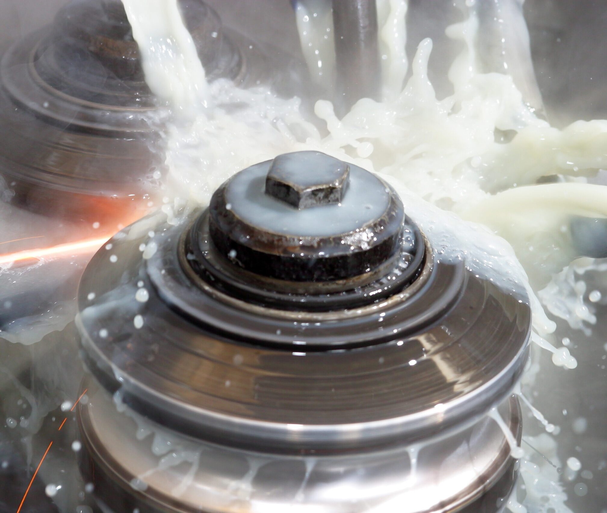 Coolant being applied to metal components during machining