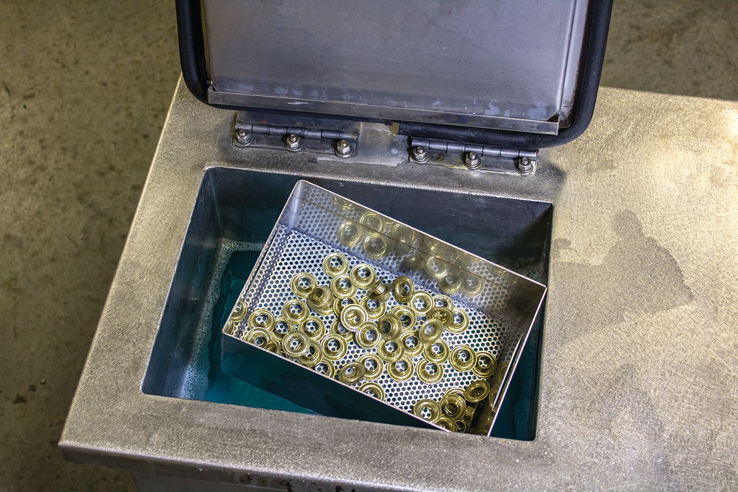 Brass components being put into ultrasonic cleaner